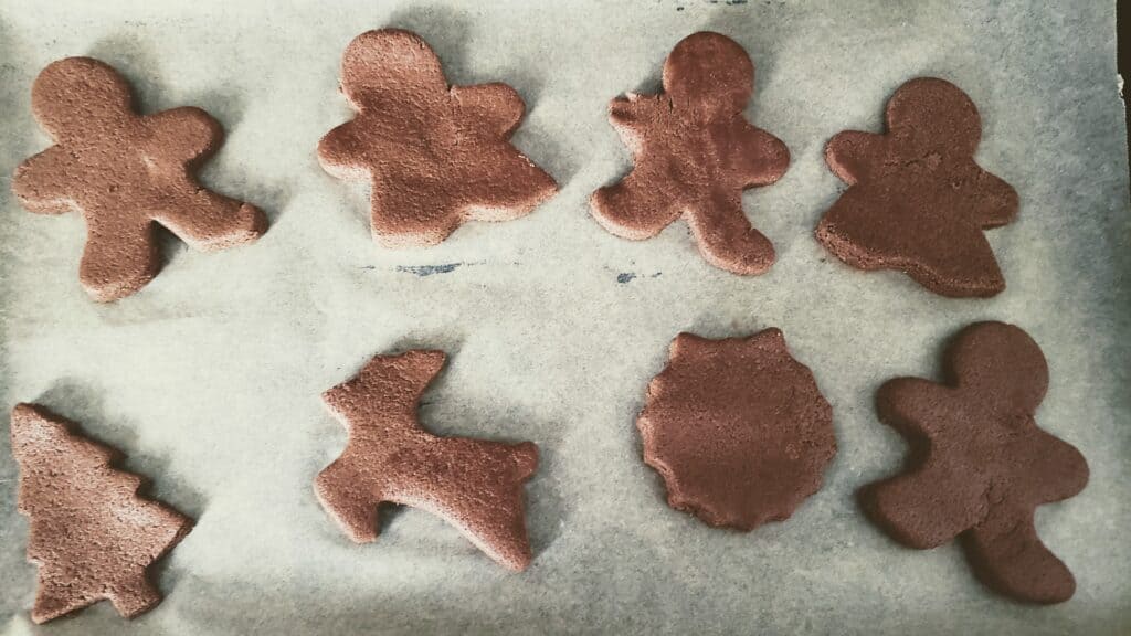 chocolate gingerbread cookies laid on parchement paper
