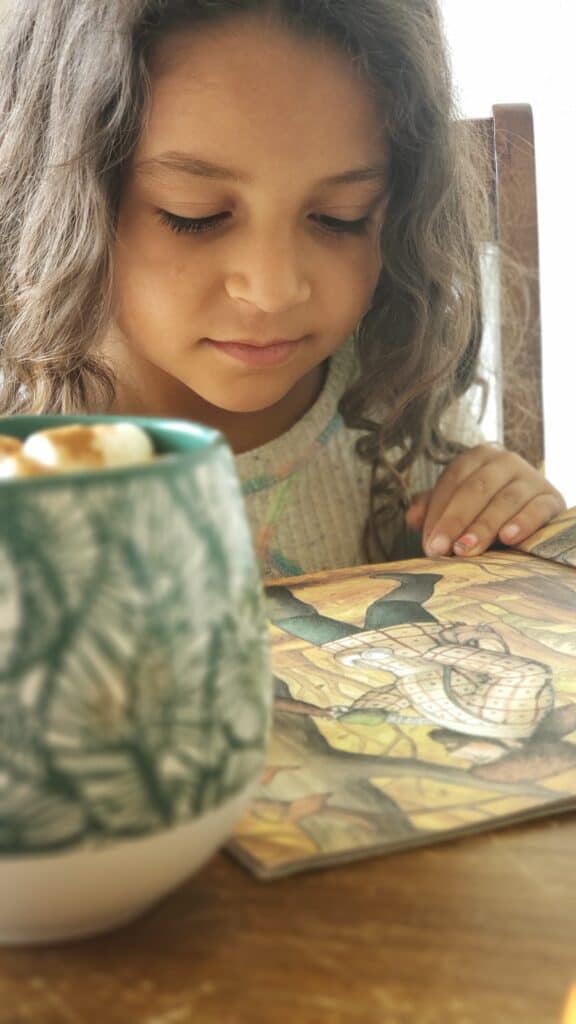a little girl reading Little House books