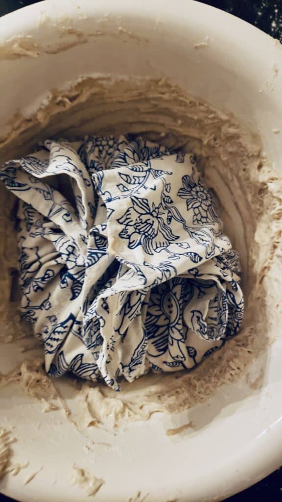 sourdough bread rising in a tea towel, making sourdough without special equipment 