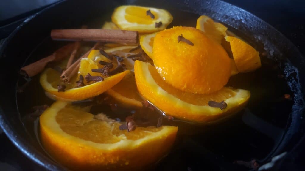 simmer pot of oranges, cinnamon sticks, and cloves