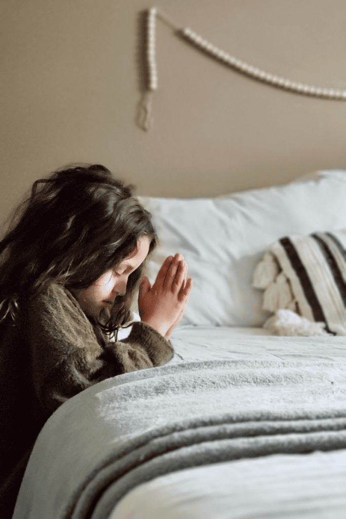 a little girl praying beside the bed, how to teach  children to pray, child praying